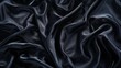 Black silk texture, suggesting luxury and elegance