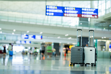 Wall Mural - Travel, Two suitcases in an empty airport hall, traveler cases in the departure airport terminal waiting for the area, vacation concept, blank space for text message or design