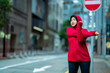 Glad smiling young asian muslim female in hijab with fitness tracker running on building background outdoor. Fitness outside, jogging in morning, body and health care, training, concept muslim sport.