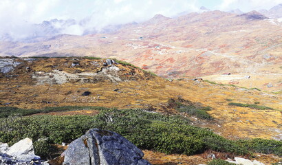 Wall Mural - cloudy alpine landscape of nathang valley, high himalaya region of east sikkim near controversial doklam plateau (india china bhutan tri junction)