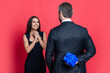 Happy Valentines day. Couple in love isolated on red. Romantic proposal with gift. Present. Man making proposal to woman. Man give present gift box for Valentines day to woman