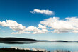 Tranquil lake scene with vivid blue sky and fluffy clouds!