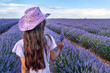 Young girl in the lavender field and cloudy sky at the background. Brihuega, Spain.