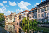 Fototapeta  - Le Petite France, the most picturesque district of old Strasbourg. Half-timbered houses with reflection in waters of the Ill channels.