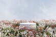3d render platform and Natural springtime background, Stone podium on colorful flowers and grass field for product stand display, advertising, mockup or etc
