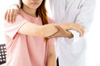 Female doctor hand rehab physical therapy by extending the pain shoulder of a patient. treatment with stretch exercises