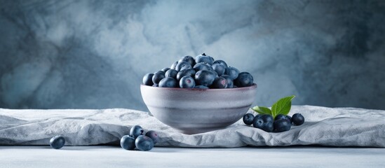 Poster - The marble table is adorned with a bowl filled with delectable fresh bilberries creating a captivating copy space image