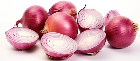 Wall Mural - Close up isolated copy space image of a group of ripe whole and sliced red onions on a white background emphasizing the food concept