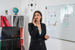 Confident serios young woman wear suit having a business conversation on phone at office