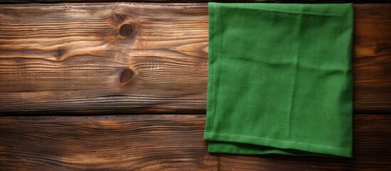 Wall Mural - An old wooden background with a green napkin providing copy space image