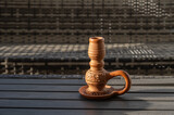 Fototapeta Natura - Clay candlestick for one candle on wooden table.