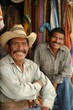 © Jorge Ferreiro - Two Men Standing in a Store