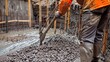 Construction worker controls concrete pouring at a building site