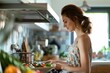 Young woman in a floral top prepares a nutritious meal in a bright, contemporary kitchen with fresh vegetables, highlighting a cozy and welcoming cooking atmosphere
