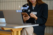 Young businessman holding credit card shopping online on her smartphone