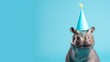 Funny hippopotamus with birthday party hat on blue background.