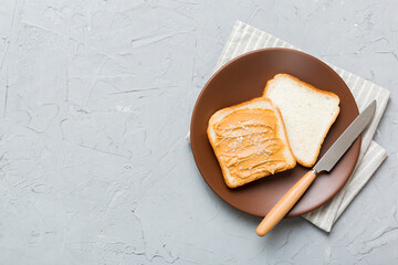 Wall Mural - Peanut butter sandwiches or toasts on light table background.Breakfast. Vegetarian food. American cuisine top view vith copy space