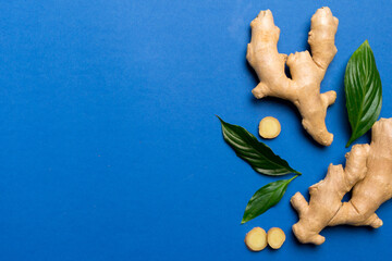 Wall Mural - Finely dry Ginger powder in bowl with green leaves isolated on colored background. top view flat lay