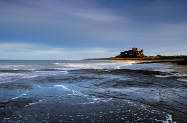 Wall Mural - sunset on bamburgh castle, on the northeast coast of england, by the village of bamburgh in northumb