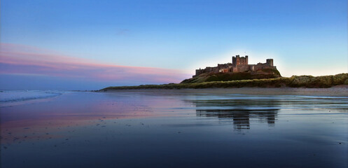 Sunset on Bamburgh Castle, on the northeast coast of England, by the village of Bamburgh in Northumberland