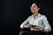 Image of young secretary woman entrepreneur politician student teacher coach wearing eyeglasses and drinking coffee looking away sitting isolated over black background