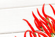 Cooking hot food with chilli pepper on white wooden table background top view copy space