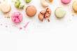 Brignt macarons for sweet break on white background top view mock up
