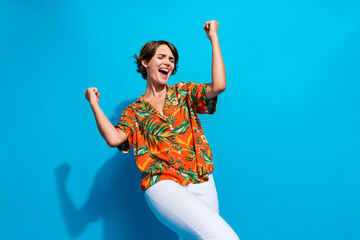 Canvas Print - Photo of cheerful overjoyed satisfied person closed eyes raise fists shout yeah isolated on blue color background