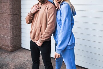 Wall Mural - Woman and Man wear a sweatshirt hoodie. Isolated close-up of streetwear apparel. Hoodies mockup.