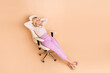 Full body photo of nice retired female hands behind head sleep office armchair wear trendy formalwear isolated on beige color background