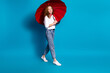 Photo portrait of nice young lady hold umbrella walking wear trendy white garment isolated on blue color background