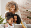 Family, together and tablet watch video for education, gaming or streaming in living room sofa in home. Happy, mother and daughters laughing with tech in house for homework, study and bonding