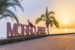 Morro Jable resort signage with palm letters outdoors on the coast on Fuerteventura island at sunset.