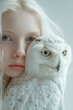 Charismatic albino girl with a white polar owl