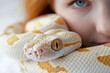 Charismatic albino girl with red hair and a white snake