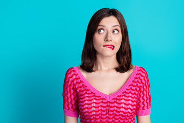 Sticker - Photo of worried confused woman with straight hairdo dressed knitwear top biting lips look empty space isolated on blue color background