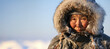 Inuit elder in fur attire against snowy Alaskan backdrop
