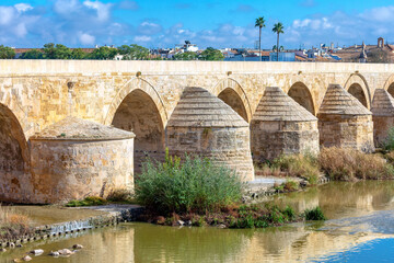 roman bridge over guadalquivir river in cordoba, spain. ancient arch bridge over the river