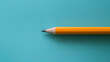 a pencil on a blue background with copy space