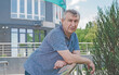 Mature European man with a good mood, outdoor portrait. The concept of life after 50 years	