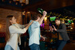 Quarrel and fight of drunk friends at sports bar