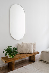 Wall Mural - Bedroom with pilea houseplant and cushion on wooden bench under mirror