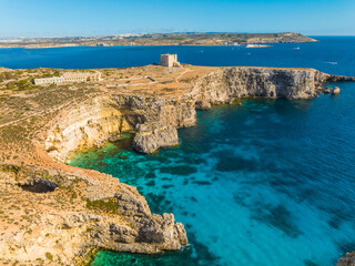 crystal lagoon and tower on comino island. mediterranean sea, malta country