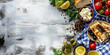 © SARATSTOCK - Greek food and flag on a blue background. Typical mediterranean dishes in Greece. Olive, olive oil, feta cheese, salad, fresh vegetables, herbs. Food menu, copy space design.