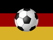 A soccer ball on a banner in the German national colors