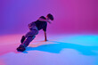 © Lustre Art Group  - Stylish dressed junior dancer, guy performing breakdance in motion in mixed neon light against vibrant gradient background. Concept of sport and hobby, music, fashion and art, movement. Ad