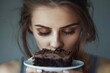 © Jorge Ferreiro - Depressed woman eats cake. Sad unhappy woman eating cake