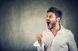 portrait of a young angry man screaming 