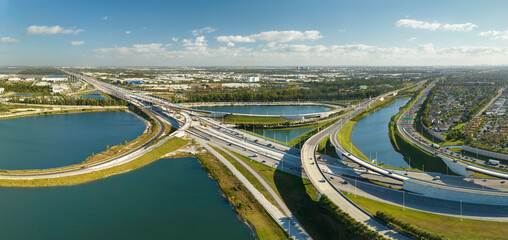 Canvas Print - Above view of wide highway crossroads in Miami, Florida with fast driving cars. USA transportation infrastructure concept