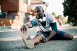 © Geber86 - Active young black man stretching on the street